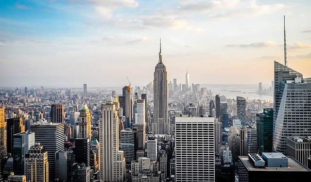 A half aerial view of New York City's skyline. The Empire State Building is in the center of the photo.
